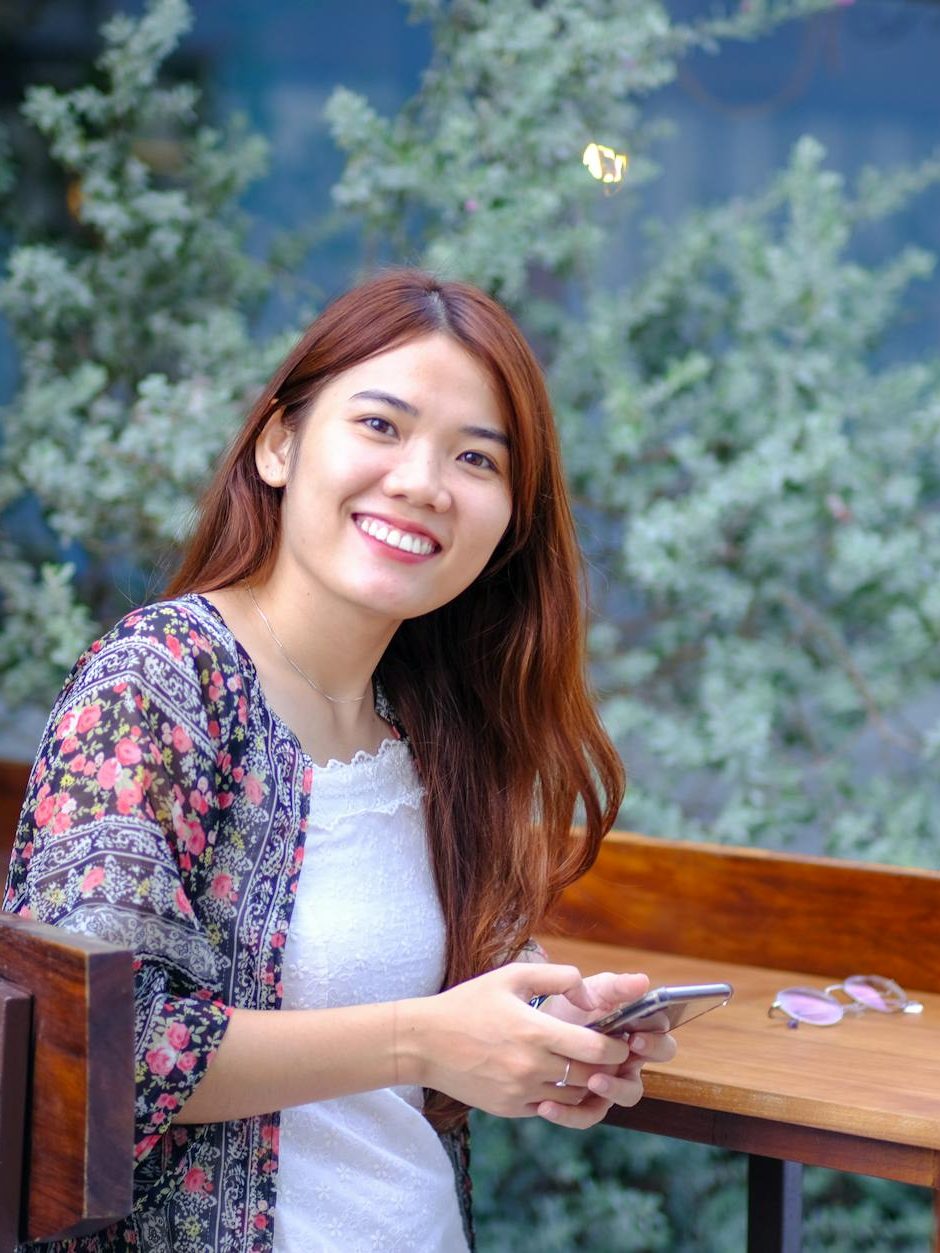 casual portrait of smiling woman outdoors